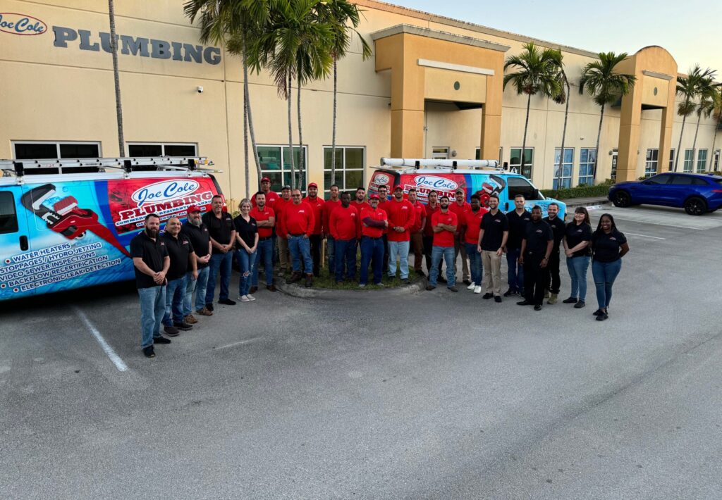 Joe Cole Plumbing technicians and service vehicles outside the Davie office